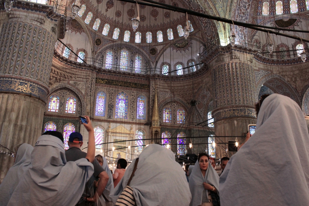 Women takes pictures of the historical and still functioning Blue Mosque. 